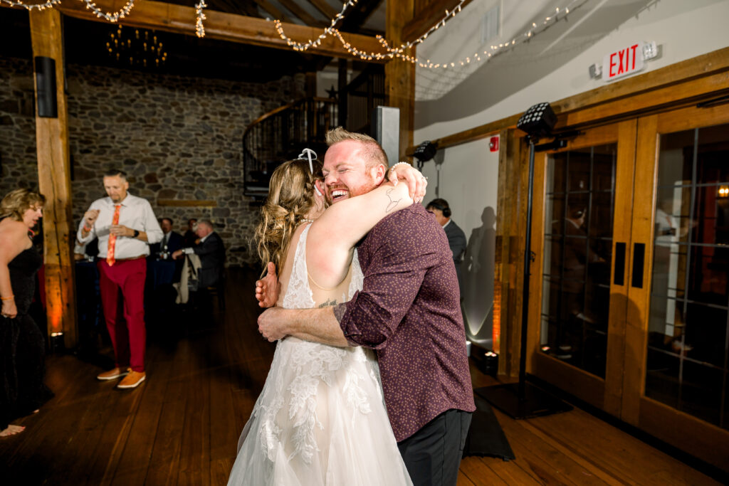Wedding photographer hugging the bride after returning from urgent care during a central Pennsylvania wedding